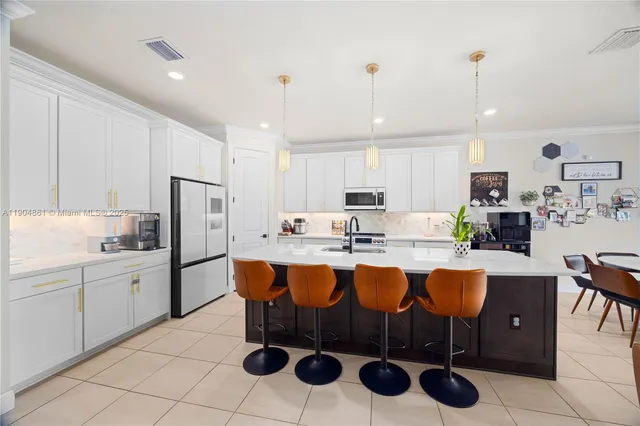 a large kitchen with a table and chairs in it