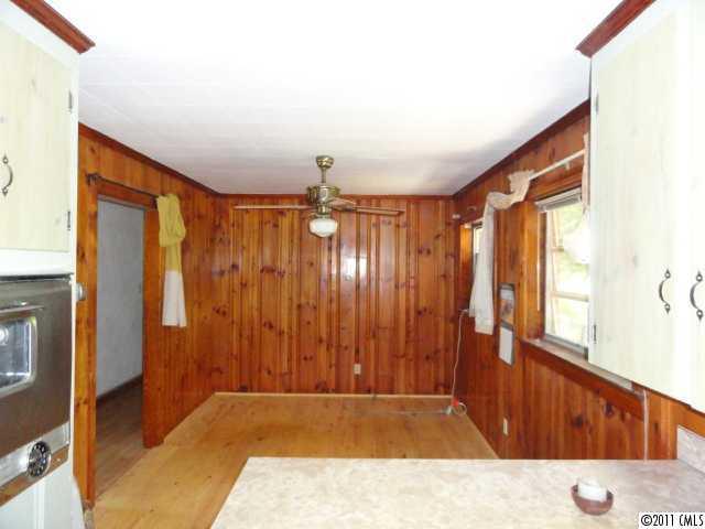 1300 Shearers Road Mooresville, NC 28115 - Photo 3 of 7 a view of an empty room with wooden floor and a window