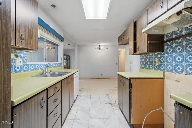 a bathroom with a granite countertop sink a mirror and bathtub