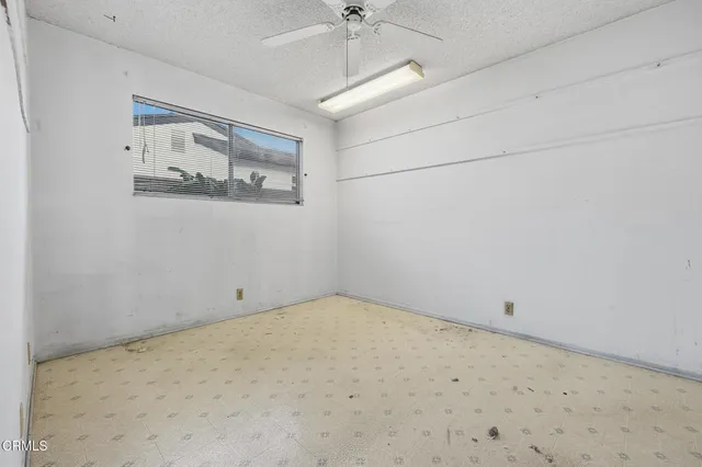 a view of a room with painting on the wall