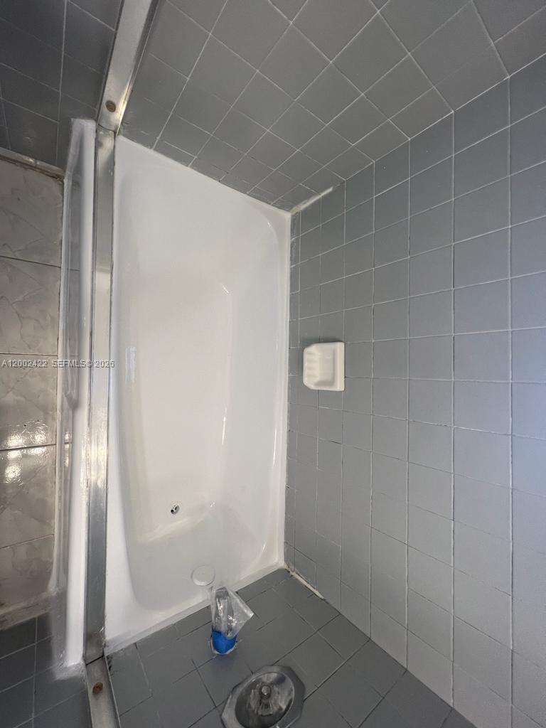 1421 Southwest 37th Avenue, Unit 3 Miami, FL 33145 - Photo 11 of 17 a bathroom with a sink and a shower