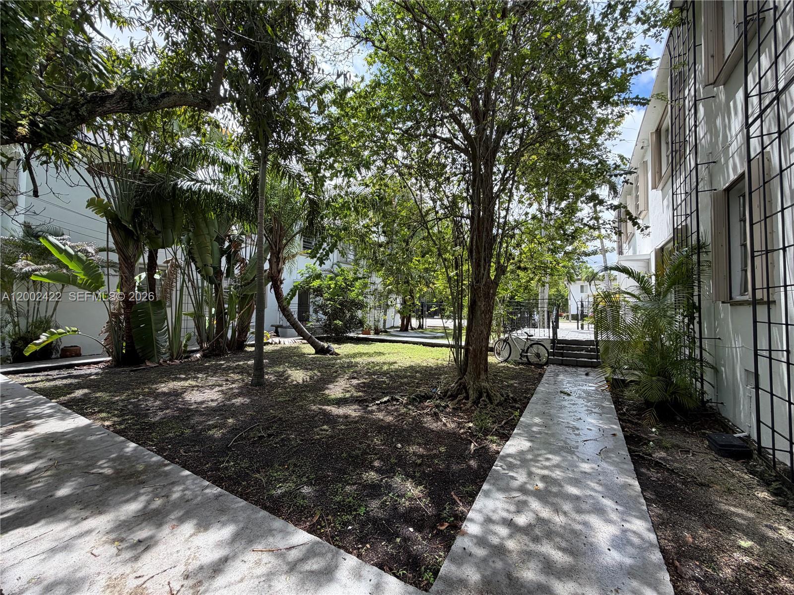 1421 Southwest 37th Avenue, Unit 3 Miami, FL 33145 - Photo 12 of 17 a view of a backyard with trees