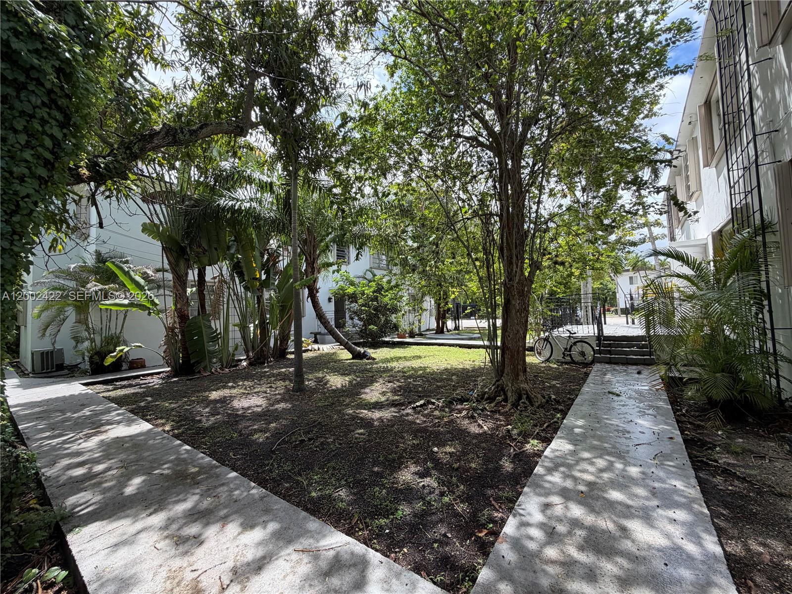 1421 Southwest 37th Avenue, Unit 3 Miami, FL 33145 - Photo 3 of 17 a view of a backyard with trees