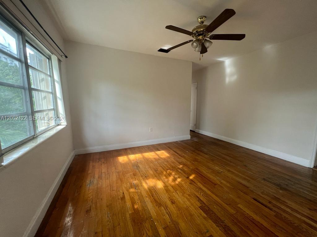 1421 Southwest 37th Avenue, Unit 3 Miami, FL 33145 - Photo 7 of 17 a view of empty room with wooden floor and fan