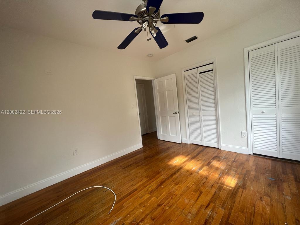 1421 Southwest 37th Avenue, Unit 3 Miami, FL 33145 - Photo 8 of 17 a view of an empty room with wooden floor
