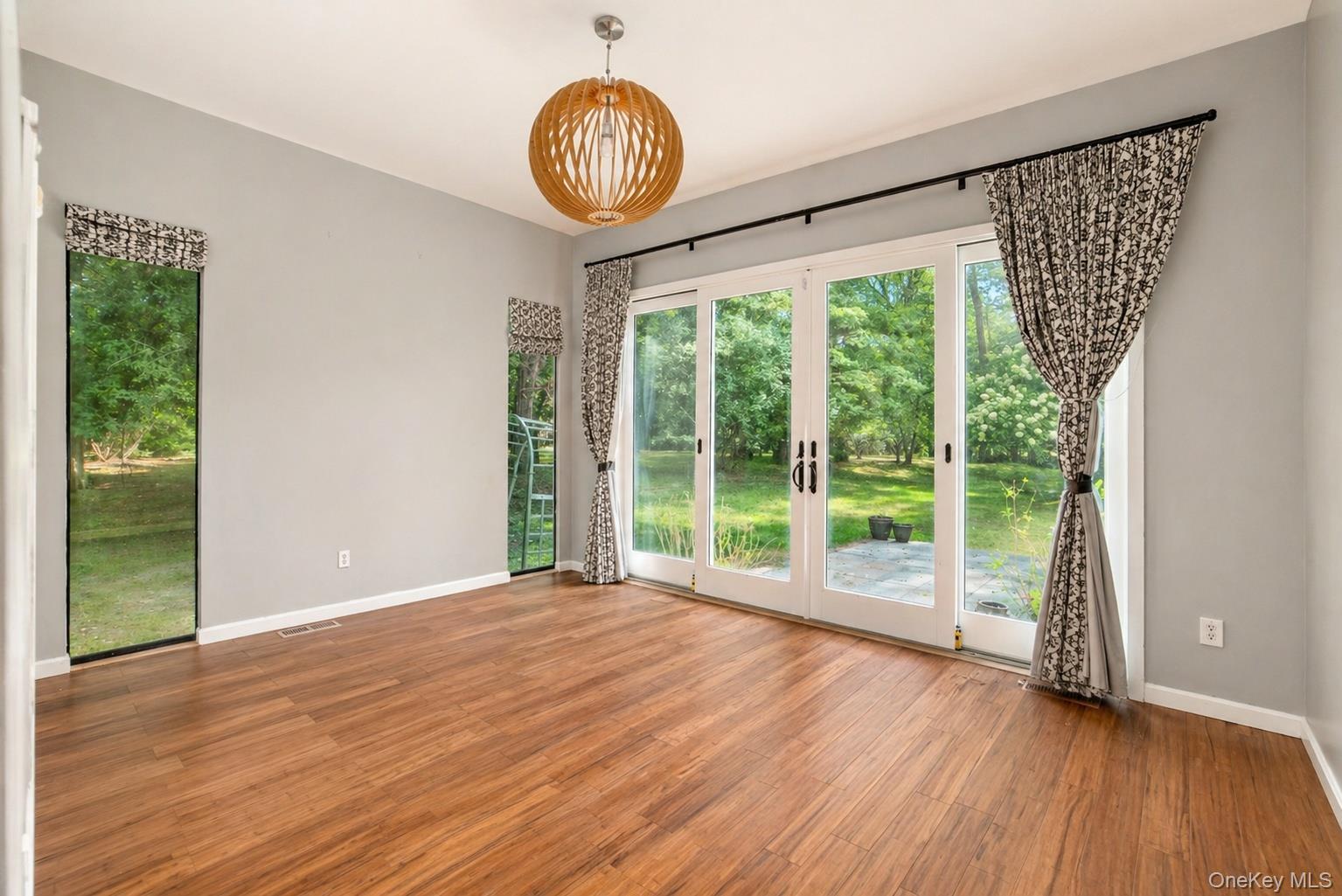 704 Short Beach Road Nissequogue, NY 11780 - Photo 13 of 25 a view of an empty room with wooden floor and a window