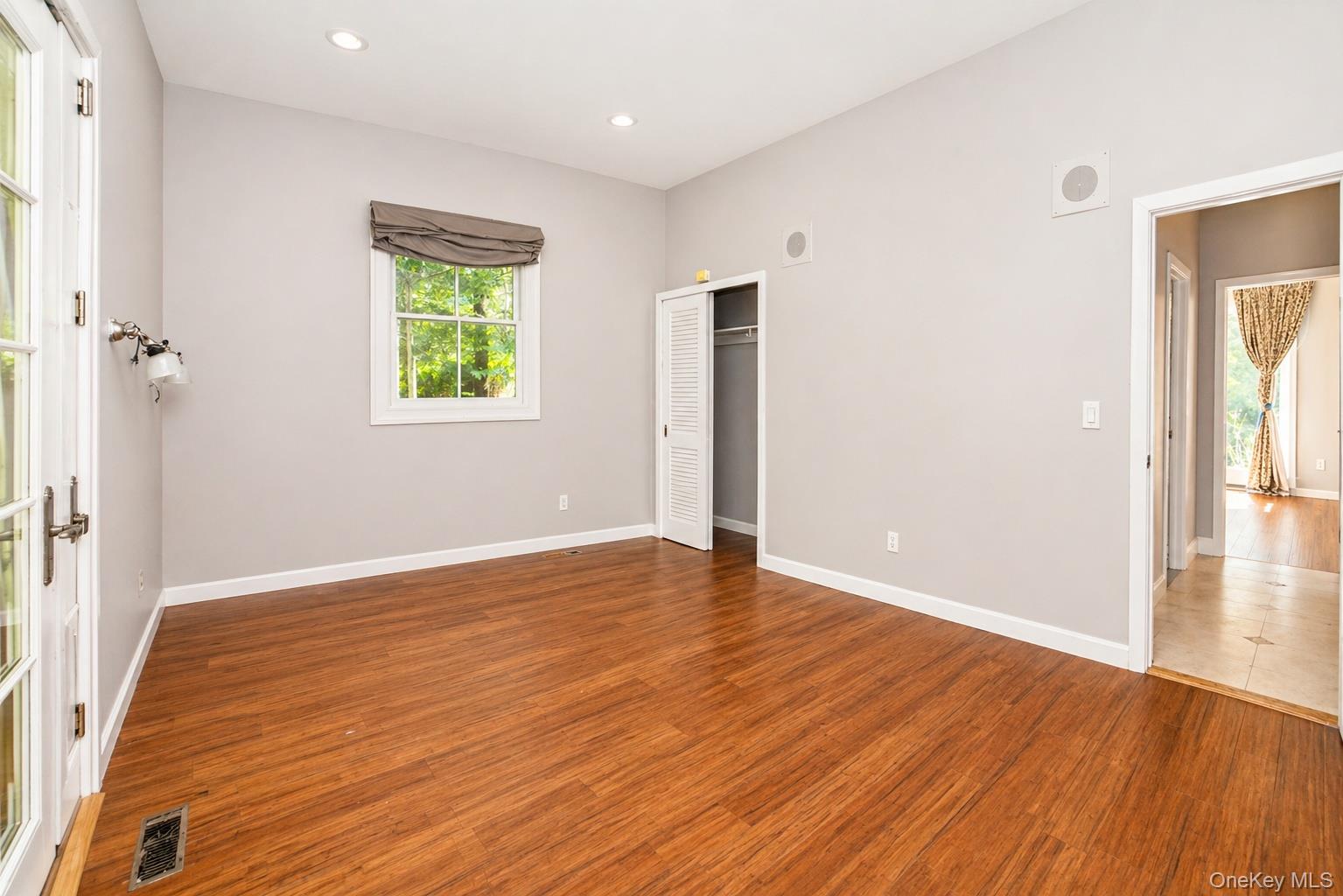 704 Short Beach Road Nissequogue, NY 11780 - Photo 14 of 25 an empty room with wooden floor and a window