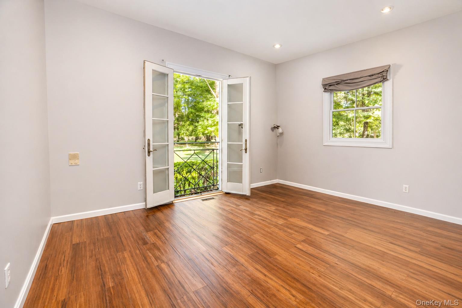 704 Short Beach Road Nissequogue, NY 11780 - Photo 15 of 25 a view of an empty room with wooden floor and a window