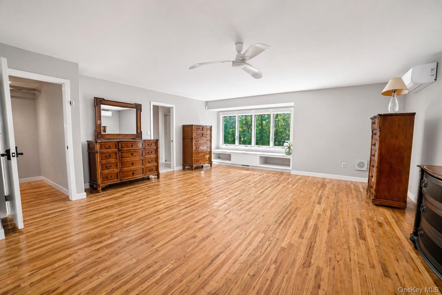 704 Short Beach Road Nissequogue, NY 11780 - Photo 16 of 25 a view of a livingroom with wooden floor and a ceiling fan