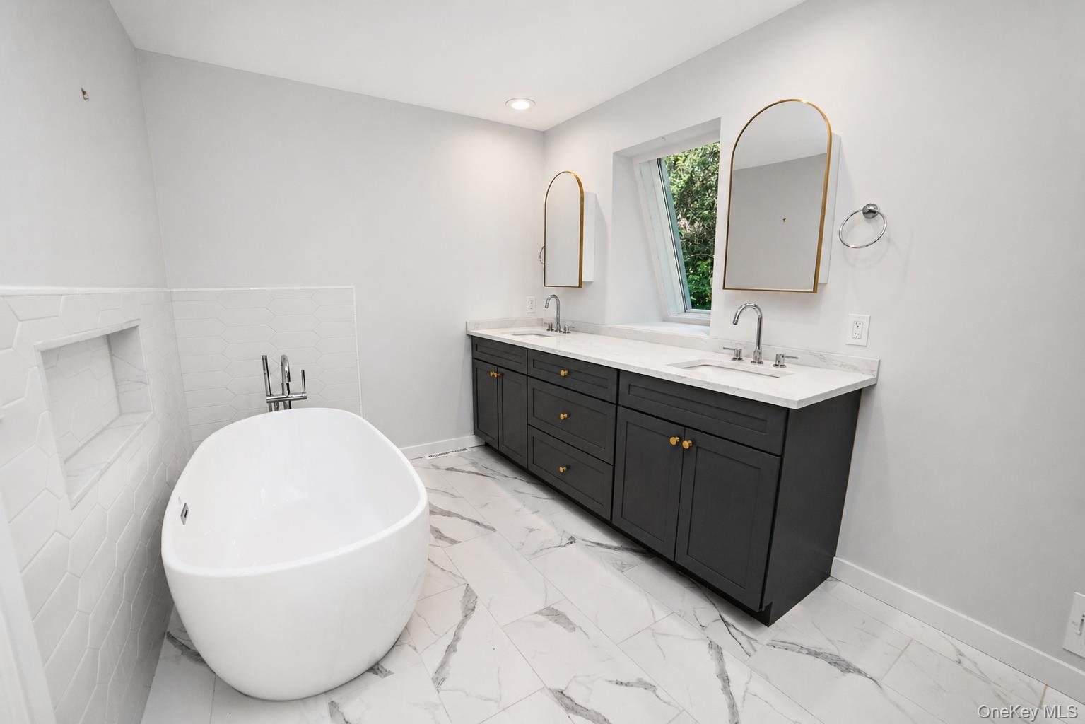 704 Short Beach Road Nissequogue, NY 11780 - Photo 17 of 25 a bathroom with a double vanity sink mirror and bathtub