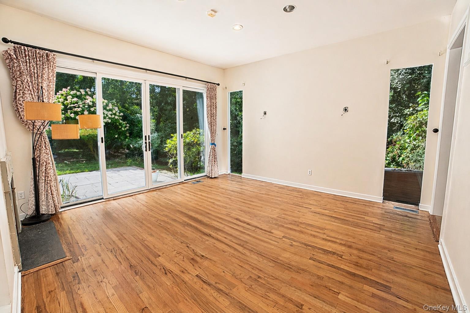 704 Short Beach Road Nissequogue, NY 11780 - Photo 7 of 25 a view of an empty room with wooden floor and a window