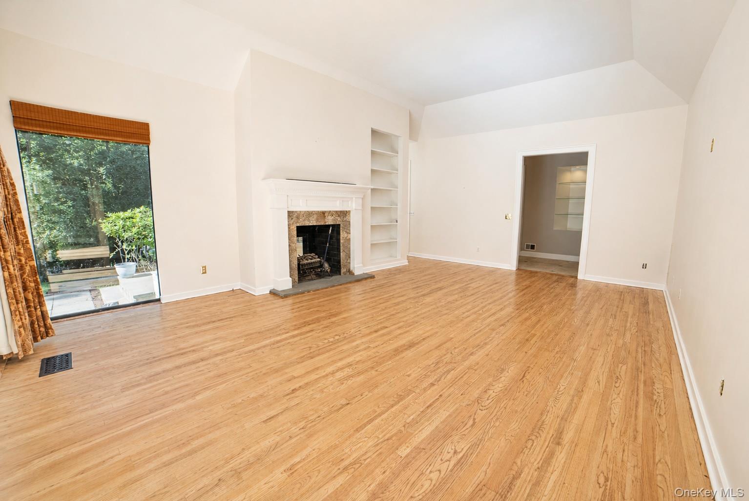 704 Short Beach Road Nissequogue, NY 11780 - Photo 9 of 25 a view of empty room with wooden floor and fan
