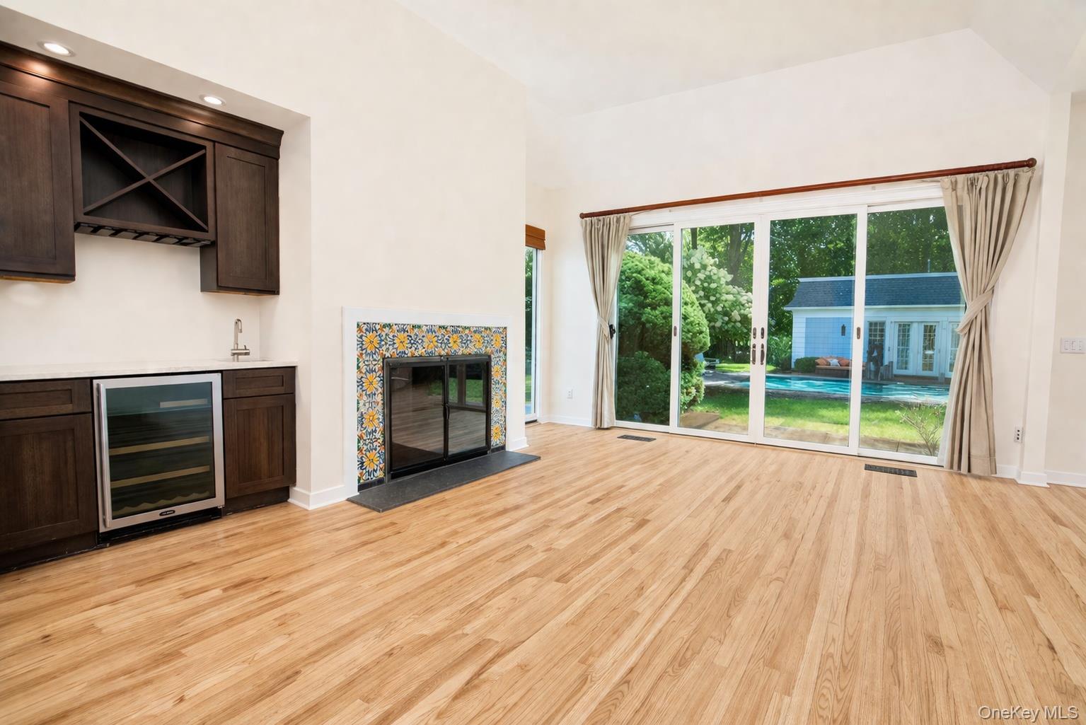 704 Short Beach Road Nissequogue, NY 11780 - Photo 10 of 25 a view of empty room with furniture and a fireplace