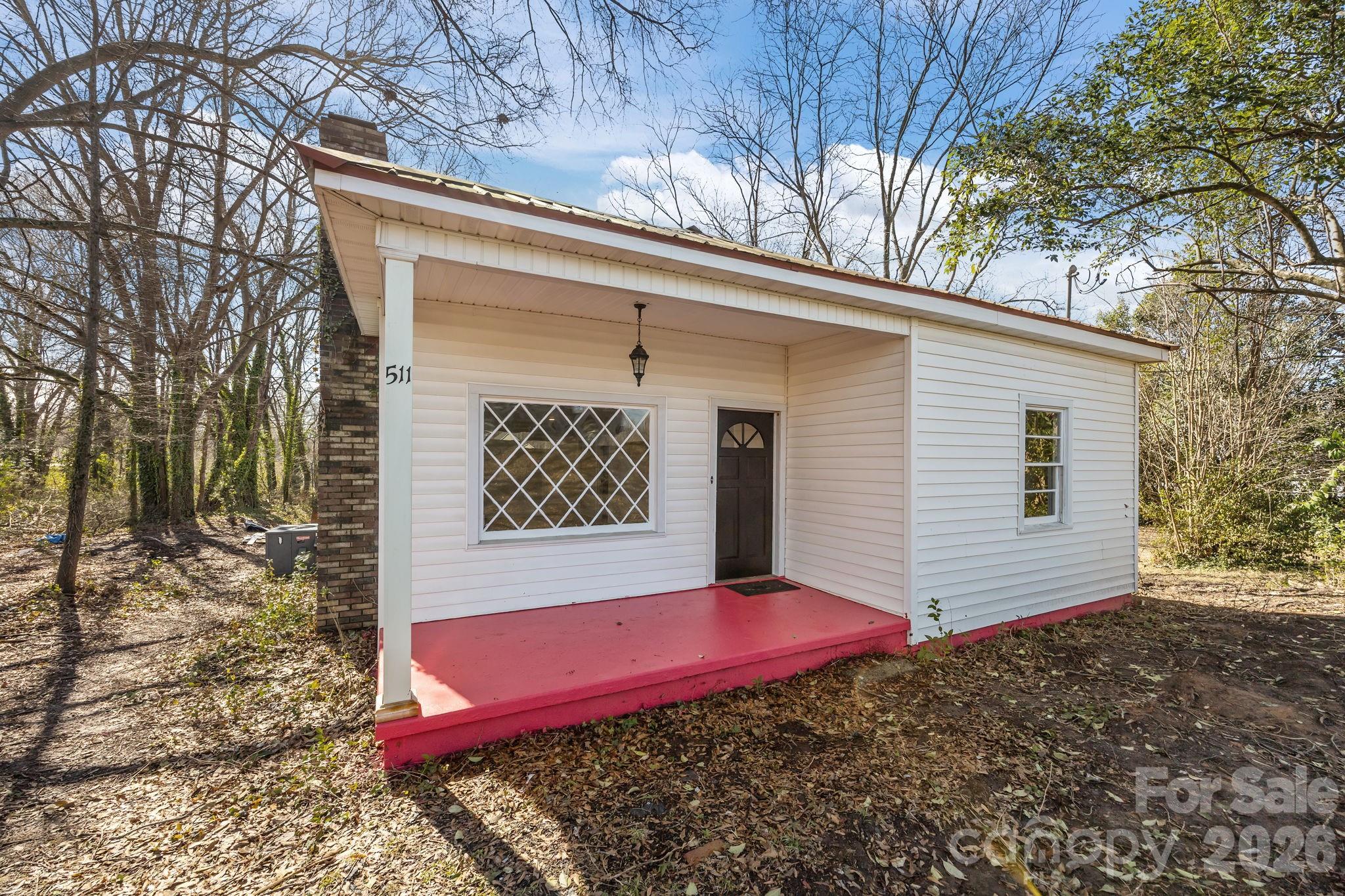 511 East Trade Street Dallas, NC 28034 - Photo 2 of 16 a front view of a house with a yard