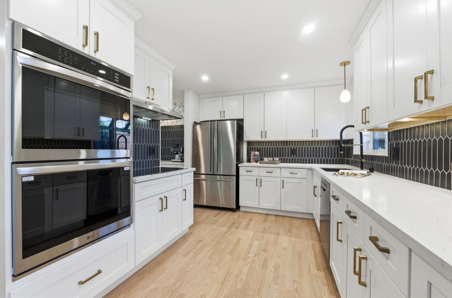 1003 Rosa Avenue Sunnyvale, CA 94086 - Photo 21 of 60 a kitchen with white cabinets and stainless steel appliances