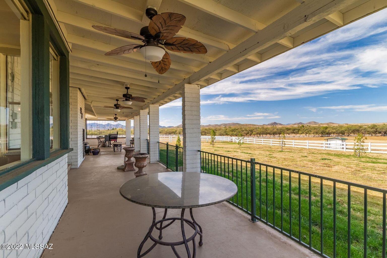 36645 South Arivaca Ranch Road Arivaca, AZ 85601 - Photo 28 of 49 a view of a balcony with table and chairs and wooden floor