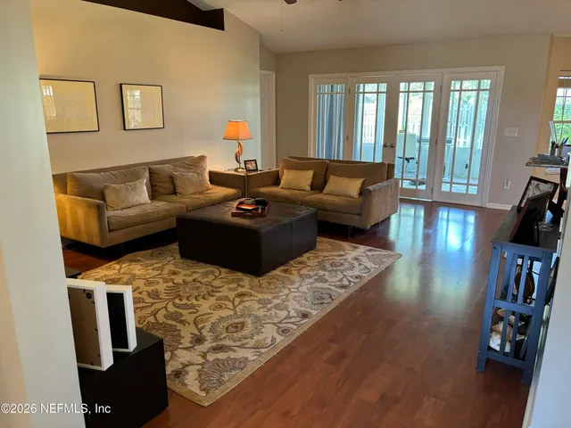 a bedroom with a bed and a dresser next to a window