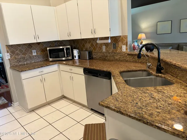 a room with furniture a rug and a window