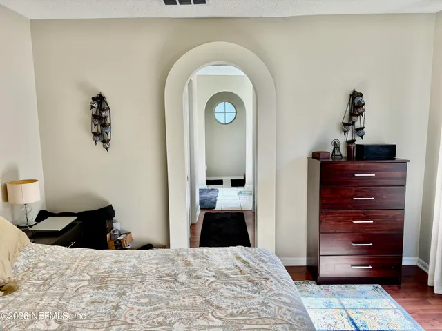 a bedroom with a bed and a window