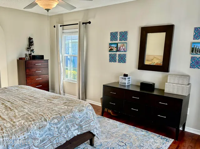 a bathroom with a sink a toilet a mirror and shower