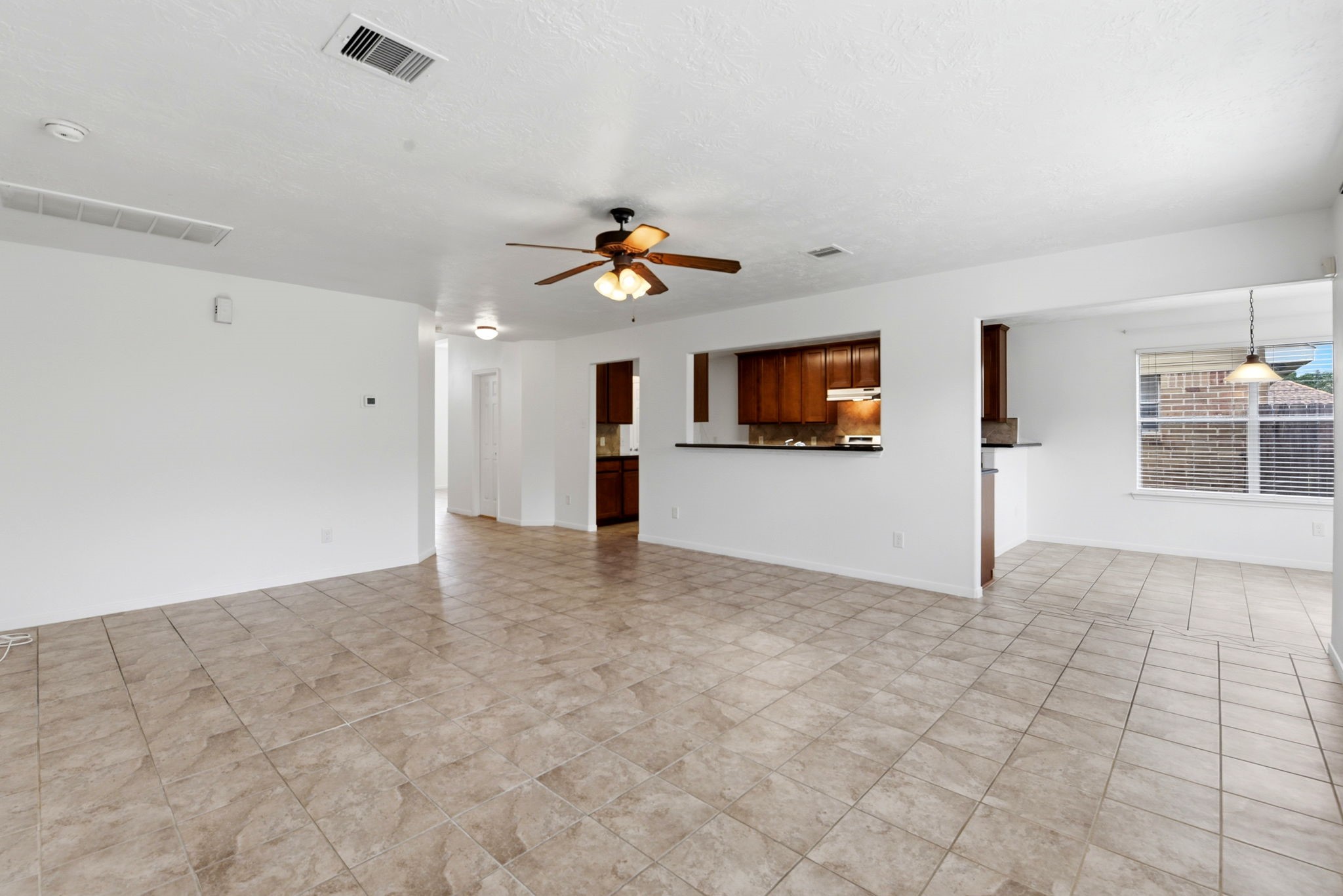 22102 Bridgestone Crossing Drive Spring, TX 77388 - Photo 15 of 38 a view of a livingroom with a ceiling fan a ceiling fan and window