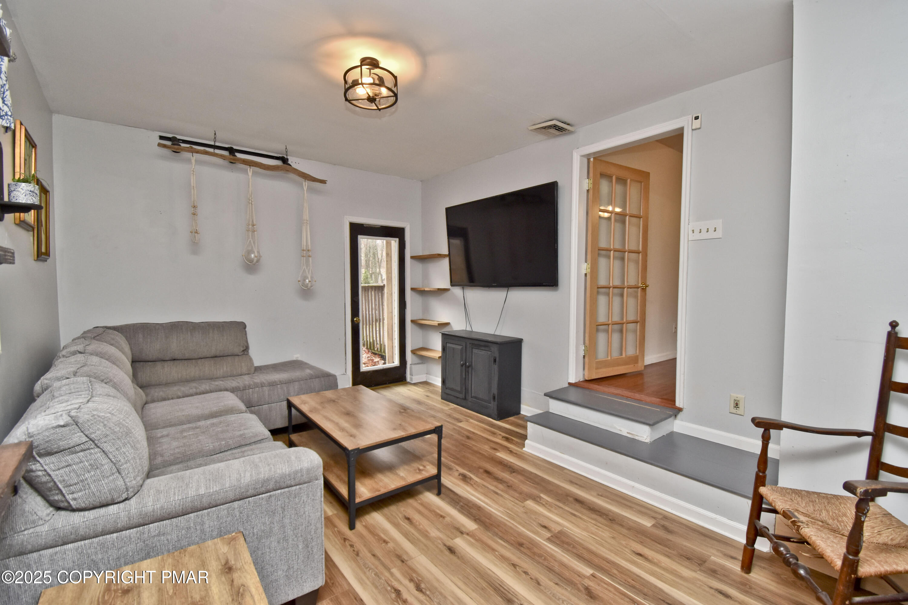 3282 Bluebird Drive Bushkill, PA 18324 - Photo 13 of 36 a living room with furniture a fireplace and a flat screen tv