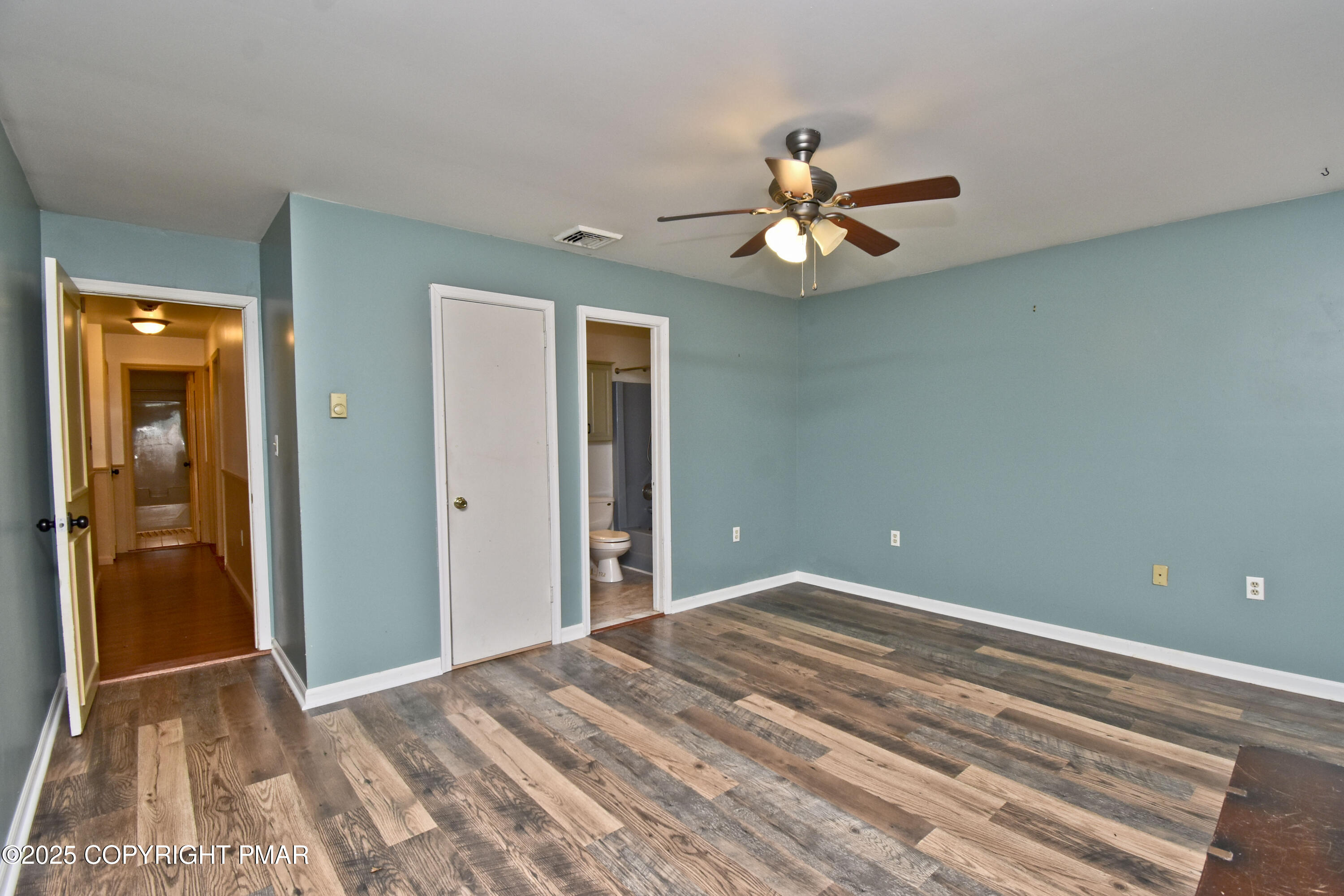 3282 Bluebird Drive Bushkill, PA 18324 - Photo 18 of 36 a bedroom with a bed and a chandelier fan