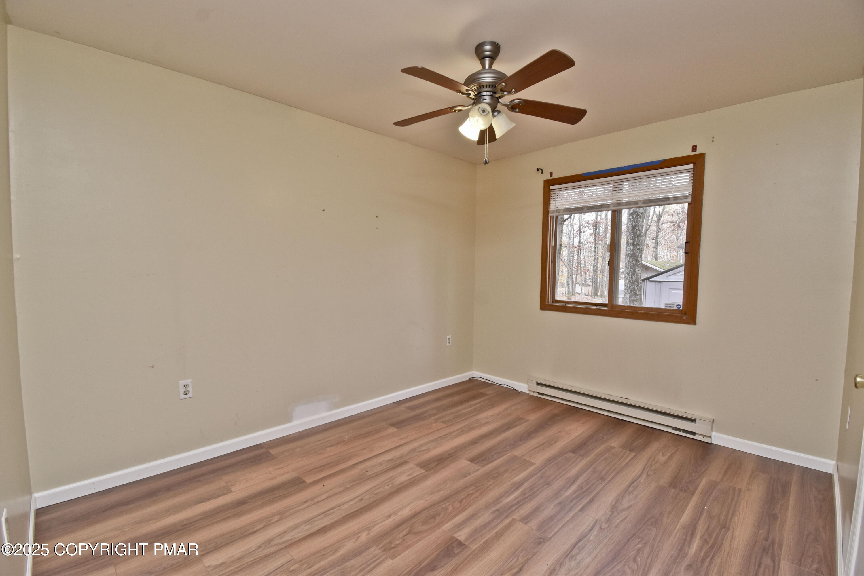 3282 Bluebird Drive Bushkill, PA 18324 - Photo 23 of 36 a view of a big room with wooden floor and chandelier fan