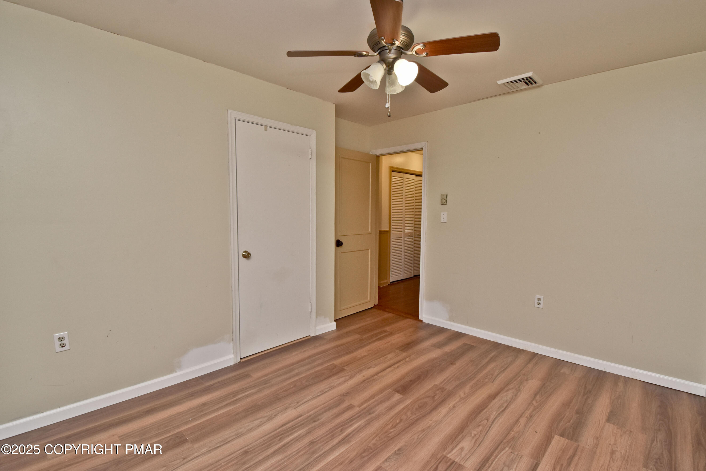 3282 Bluebird Drive Bushkill, PA 18324 - Photo 24 of 36 an empty room with wooden floor fan and windows