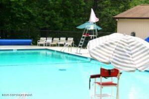 3282 Bluebird Drive Bushkill, PA 18324 - Photo 35 of 36 a swimming pool with a yard and seating space