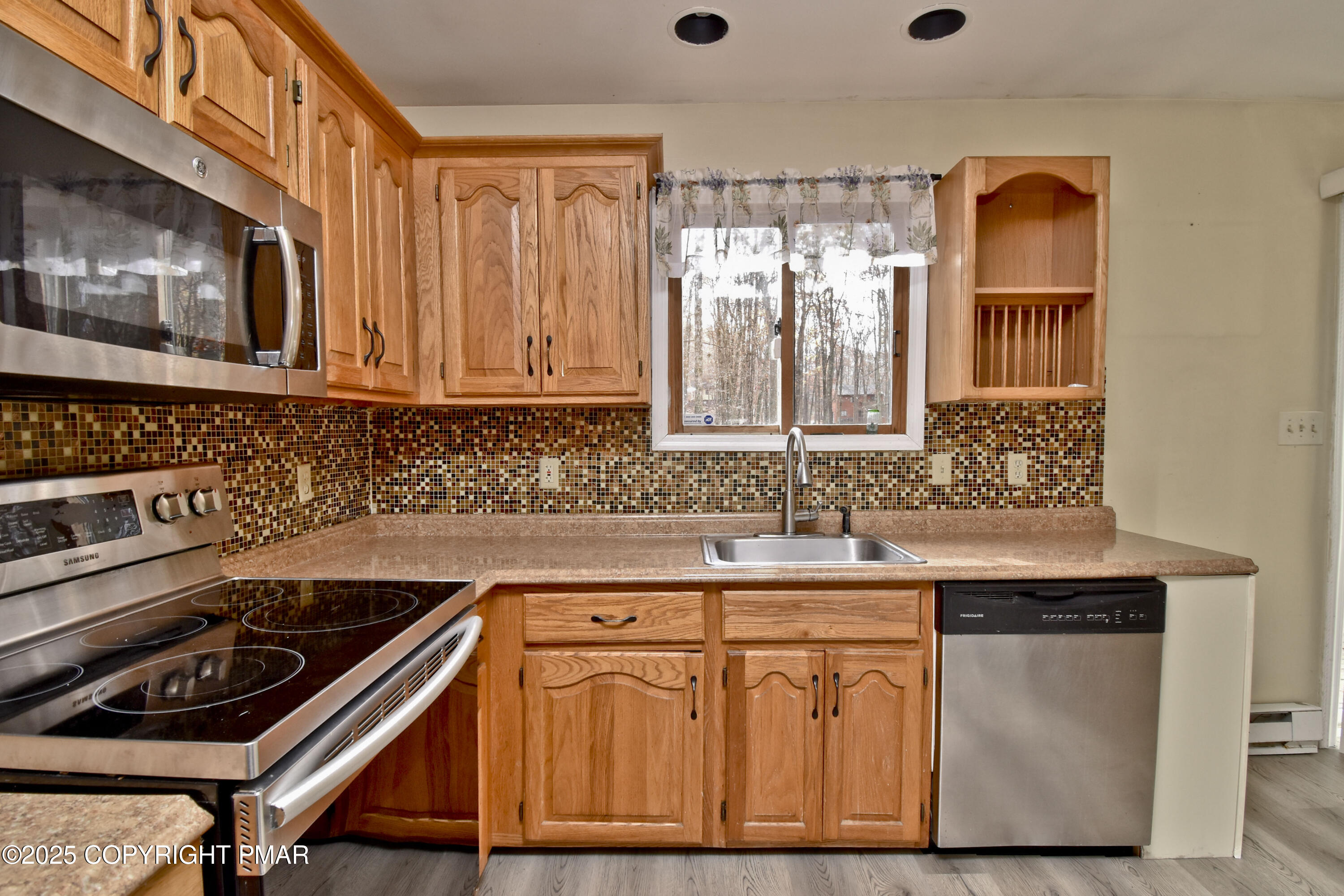 3282 Bluebird Drive Bushkill, PA 18324 - Photo 10 of 36 a kitchen with granite countertop a sink a stove and cabinets