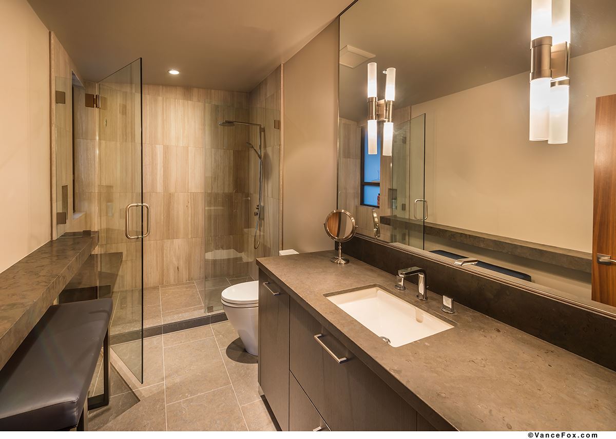 10507 Kaweah Circle Truckee, CA 96161 - Photo 2 of 10 a bathroom with a granite countertop sink a toilet a mirror and shower