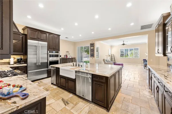 a kitchen with stainless steel appliances a sink and a refrigerator