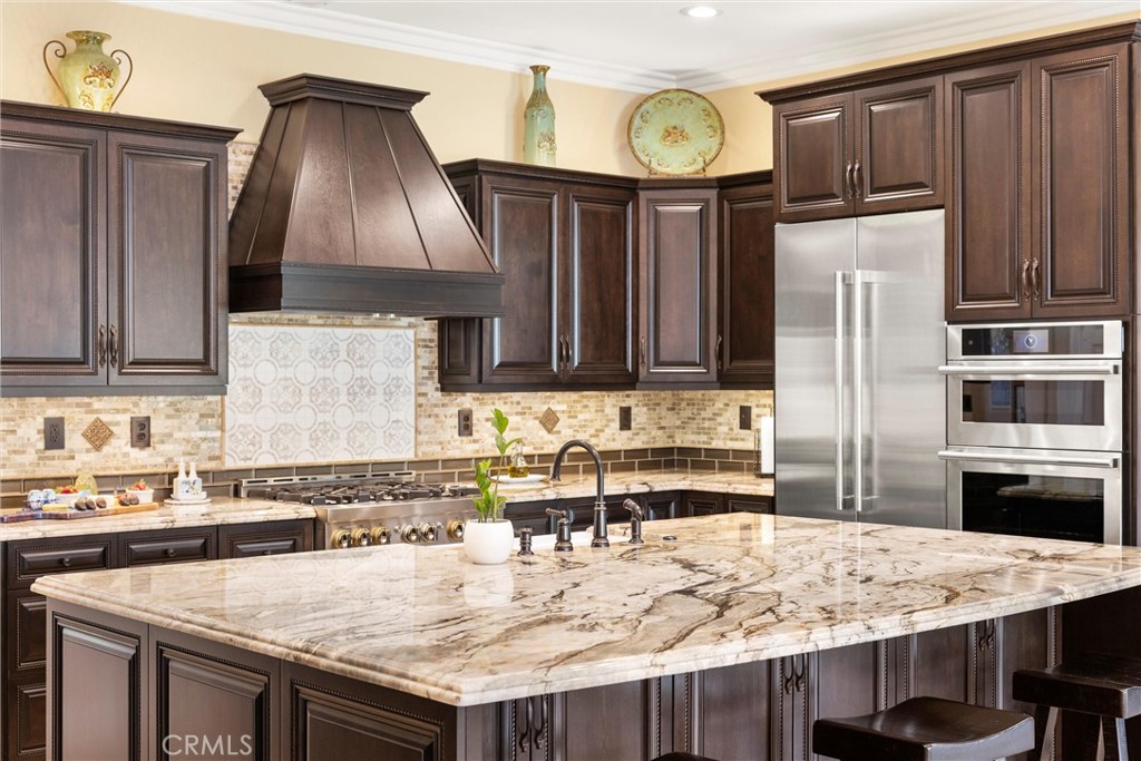 5810 Etiwanda Avenue Rancho Cucamonga, CA 91739 - Photo 16 of 68 a kitchen with granite countertop a stove a oven a refrigerator a sink and dishwasher