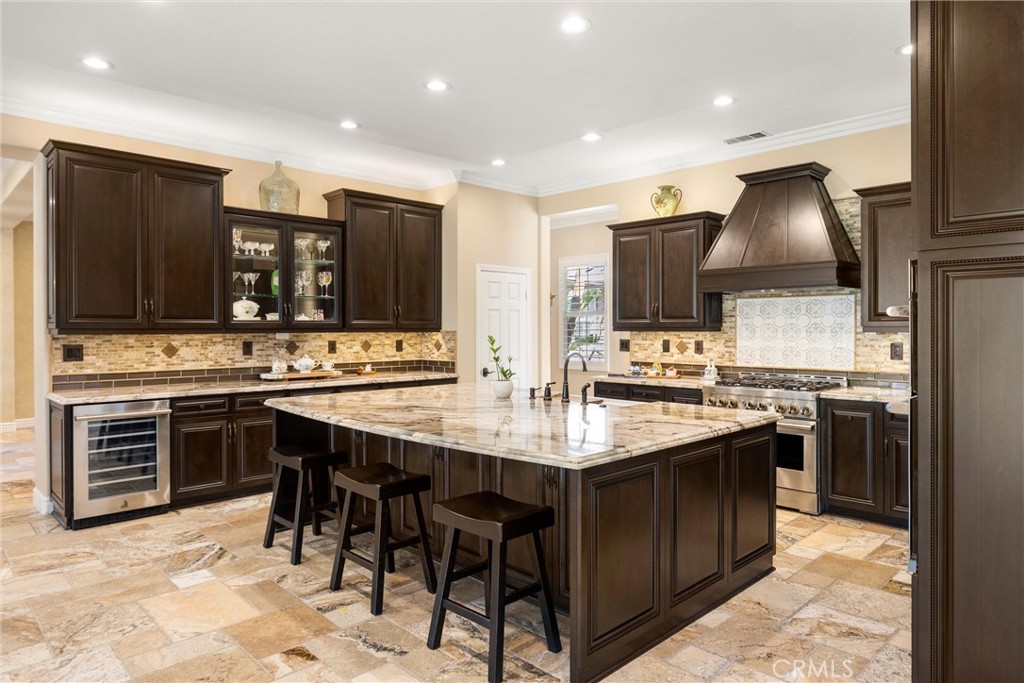 5810 Etiwanda Avenue Rancho Cucamonga, CA 91739 - Photo 18 of 68 a kitchen with stainless steel appliances kitchen island granite countertop a sink stove and refrigerator