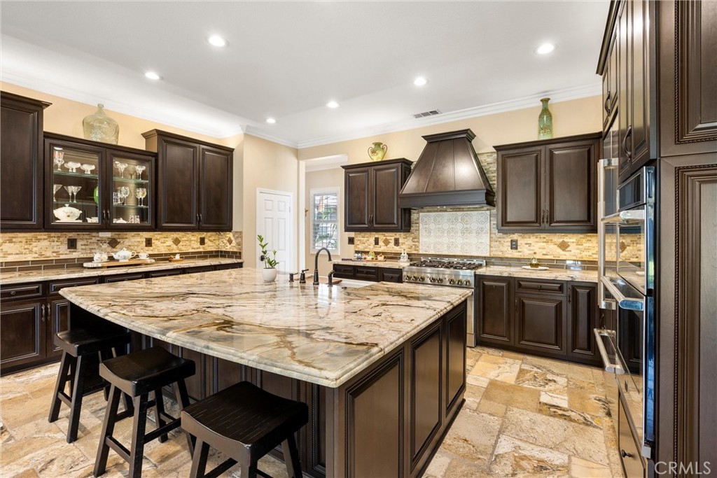 5810 Etiwanda Avenue Rancho Cucamonga, CA 91739 - Photo 19 of 68 a kitchen with stainless steel appliances granite countertop a stove refrigerator sink and cabinets