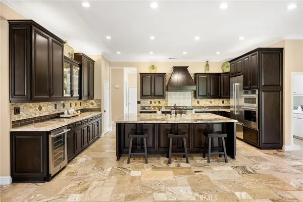 a spacious bathroom with a granite countertop toilet a sink and bathtub