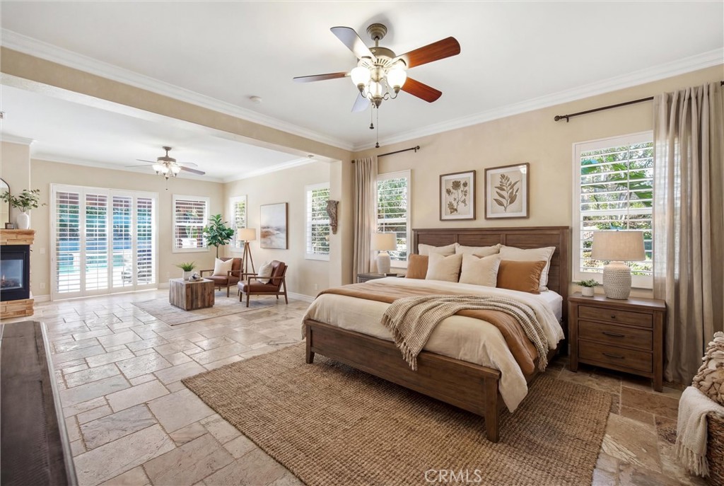 5810 Etiwanda Avenue Rancho Cucamonga, CA 91739 - Photo 24 of 68 a spacious bedroom with a bed couch and a large window