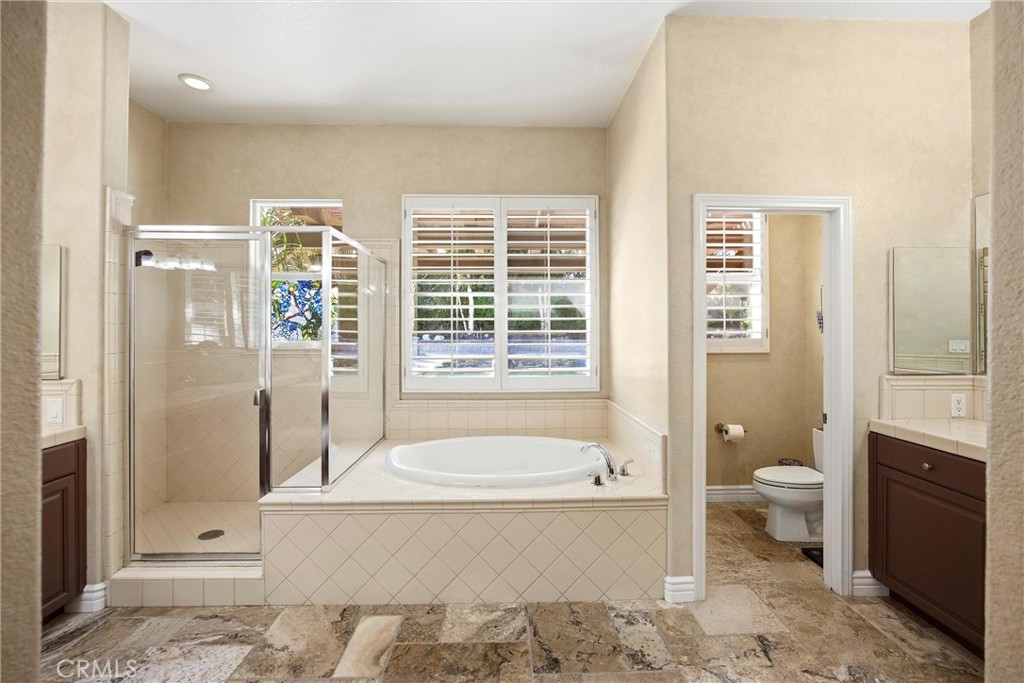 5810 Etiwanda Avenue Rancho Cucamonga, CA 91739 - Photo 25 of 68 a spacious bathroom with a granite countertop toilet a sink and bathtub