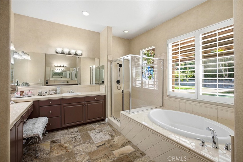 5810 Etiwanda Avenue Rancho Cucamonga, CA 91739 - Photo 26 of 68 a spacious bathroom with a granite countertop tub sink shower and mirror