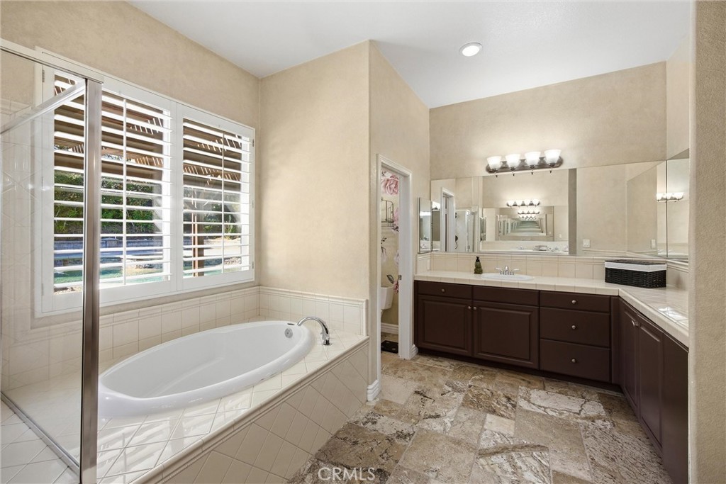 5810 Etiwanda Avenue Rancho Cucamonga, CA 91739 - Photo 27 of 68 a bathroom with a bathtub sink and double vanity