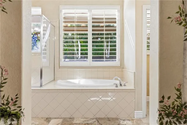 a bathroom with a toilet a sink a mirror and a shower