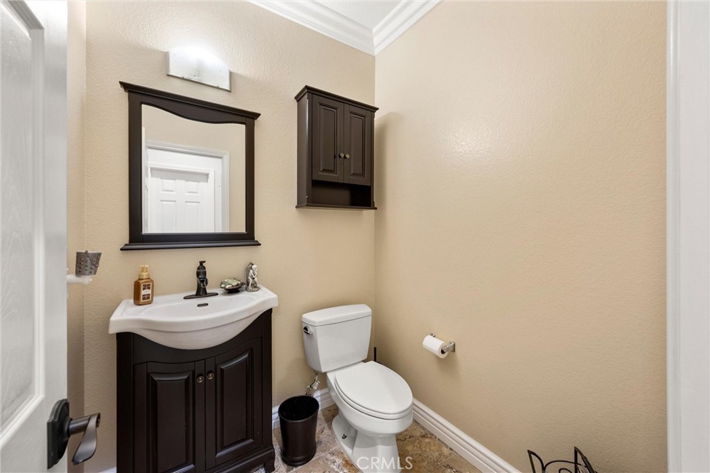 5810 Etiwanda Avenue Rancho Cucamonga, CA 91739 - Photo 31 of 68 a bathroom with a toilet a sink and mirror