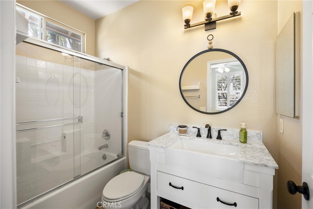 5810 Etiwanda Avenue Rancho Cucamonga, CA 91739 - Photo 37 of 68 a bathroom with a toilet a sink a mirror and a shower