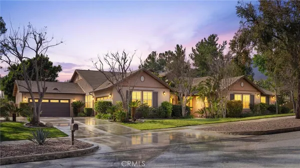 a front view of a house with yard and green space