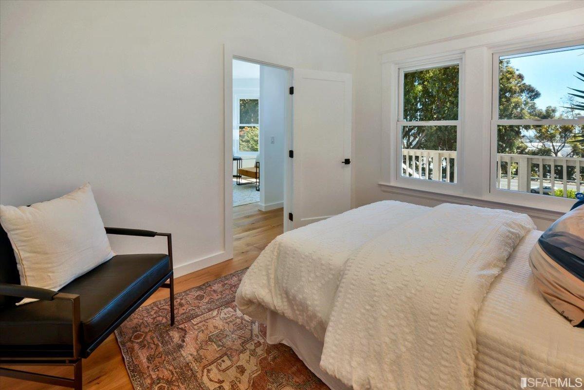 334 Holladay Avenue San Francisco, CA 94110 - Photo 14 of 36 a bedroom with a bed and wooden floor