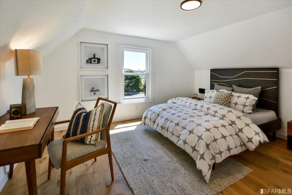 334 Holladay Avenue San Francisco, CA 94110 - Photo 16 of 36 a bedroom with a bed a table and chair