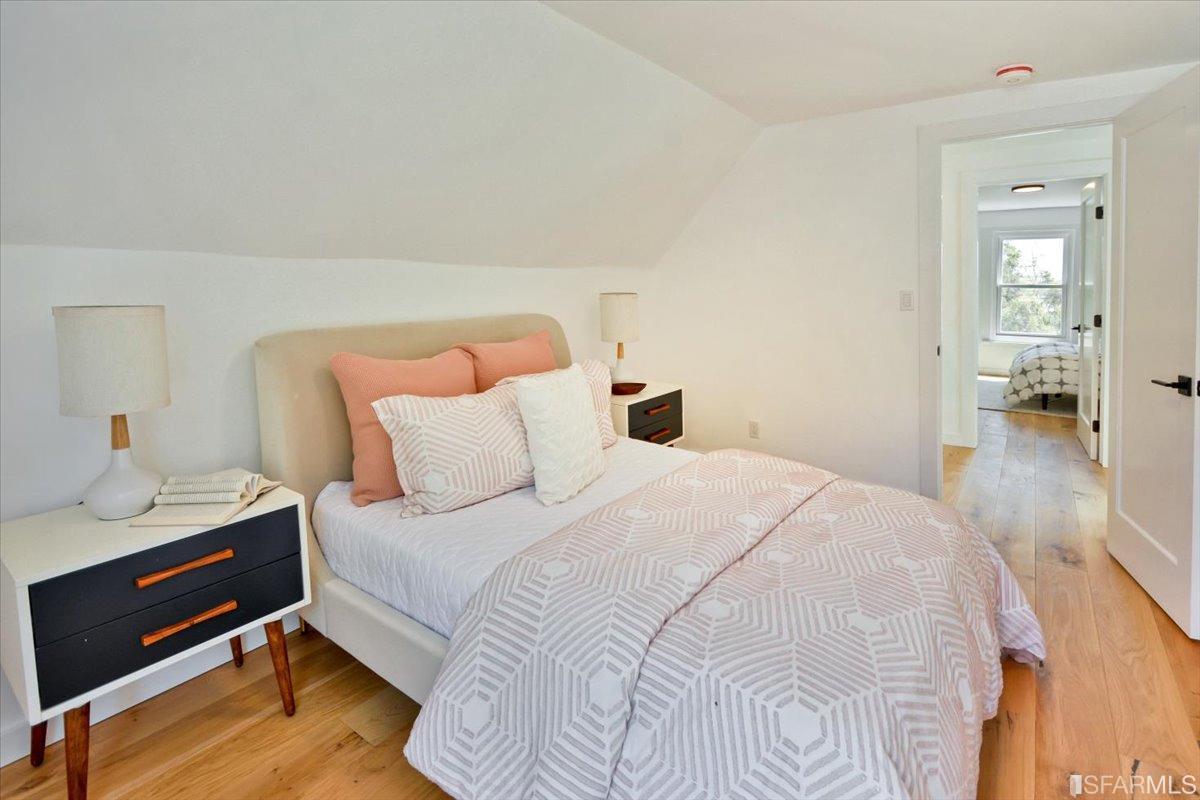 334 Holladay Avenue San Francisco, CA 94110 - Photo 22 of 36 a bedroom with a bed and a mirror