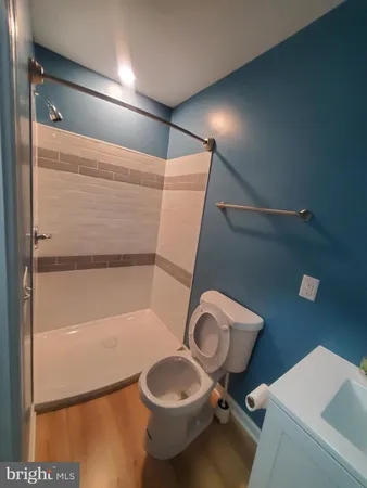 a bathroom with a toilet and a shower