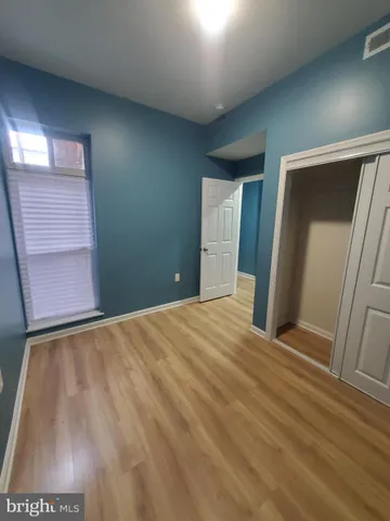 a view of an empty room and wooden floor